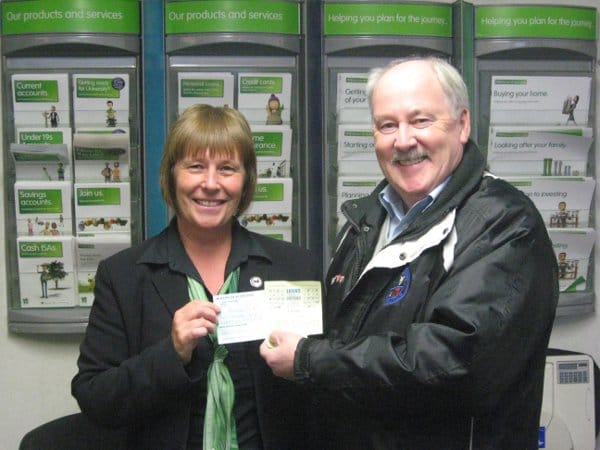 Dennis Fenton presents a cheque for £1750 to Loons Lottery Jackpot winner, Pamela Elms